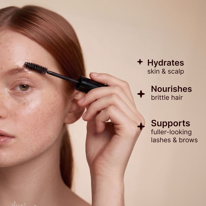 Woman applying Soulsation Organic Castor Oil to eyebrows with the included precision applicator for healthy-looking brows.