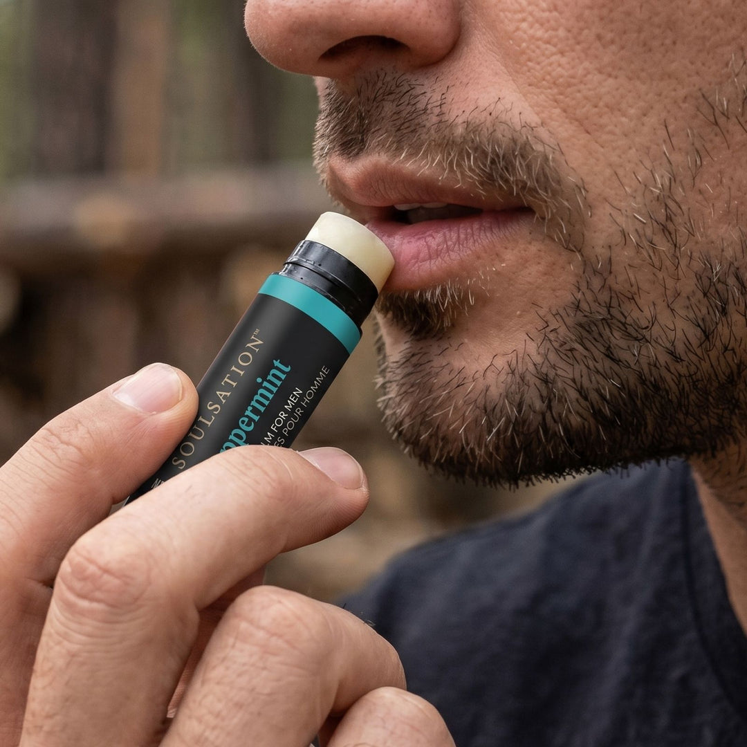 Man applying the Soulsation organic lip balm for men to moisturize dry and chapped lips