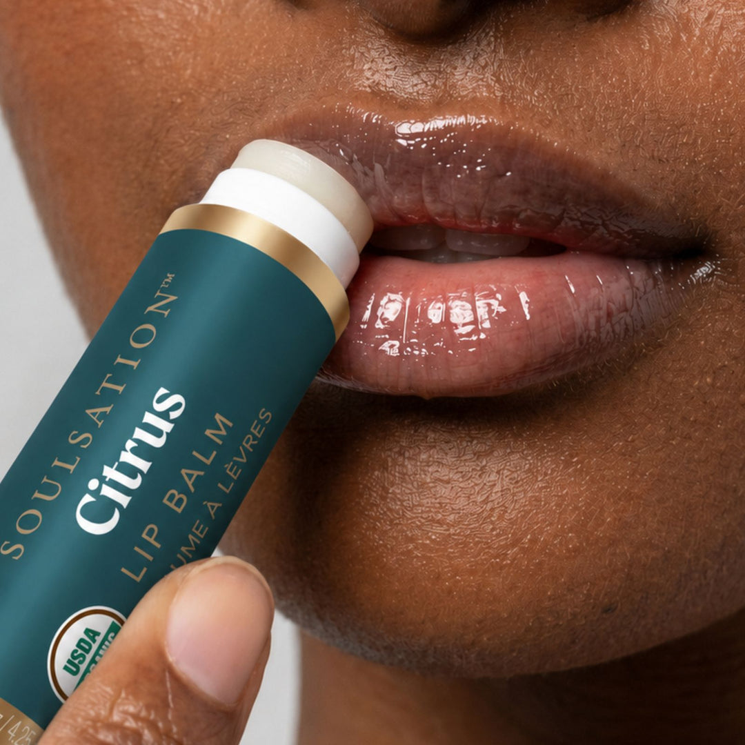 Woman applying Soulsation Organic Lip Balm for soft, hydrated, and healthy-looking lips
