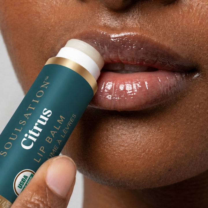 Woman applying Soulsation Organic Lip Balm for soft, hydrated, and healthy-looking lips